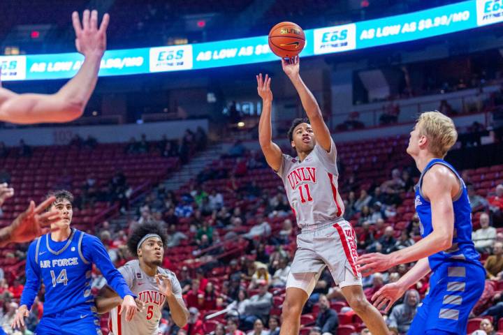 UNLV guard Dedan Thomas Jr. (11) gets off a shot over Air Force Falcons forward Rytis Petraitis ...