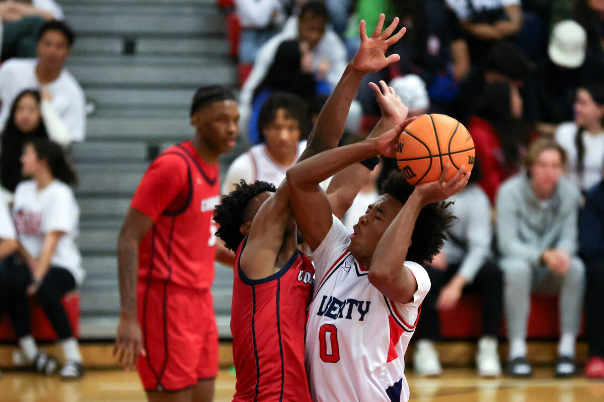 Liberty guard Tyus Thomas (0) shoots against Coronado guard Jonny Collins (0) during the second ...