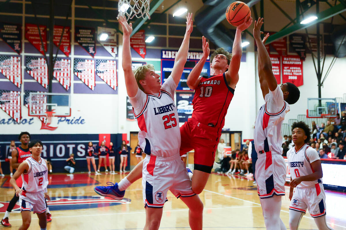 Coronado forward JJ Buchanan (10) shoots against Liberty forward Tyler Bright (25) and forward ...