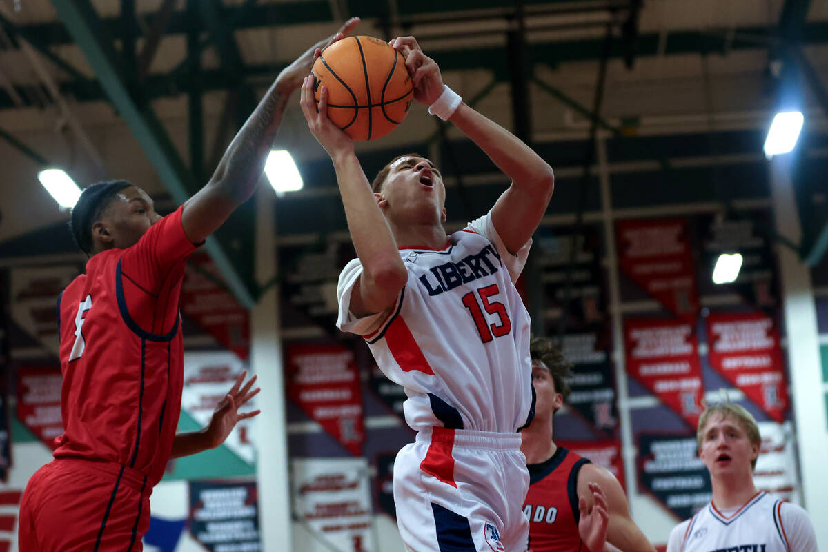 Liberty forward Dante Steward (15) shoots but is thwarted by Coronado's Lantz Stephenson (5) du ...