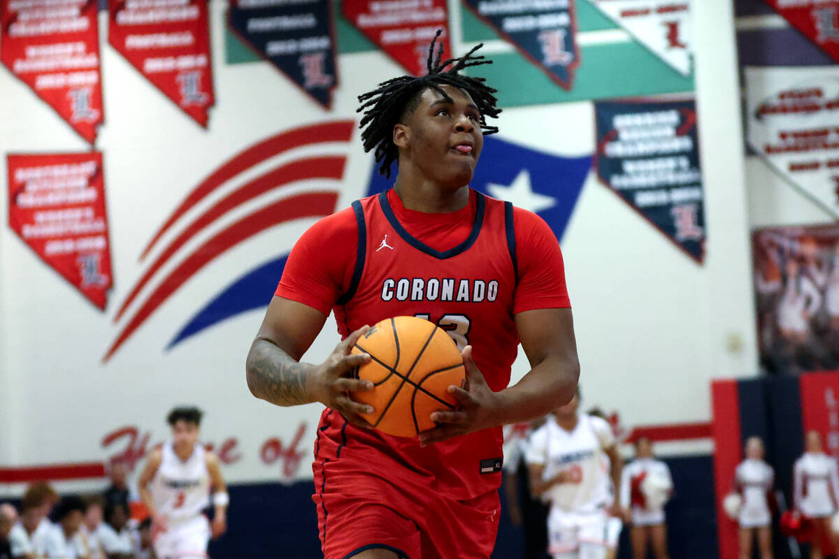 Coronado center Tee Bartlett (13) drives toward the hoop before dunking during the second half ...