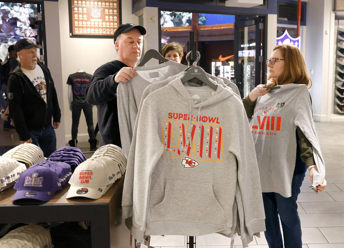 Shoppers, including Jean Ziak of Chicago, right, a Kansas City Chiefs fan, checks out Super Bow ...