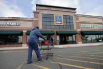 In this Wednesday, May 31, 2017, photo, a customer approaches the entrance of an Aldi food mark ...