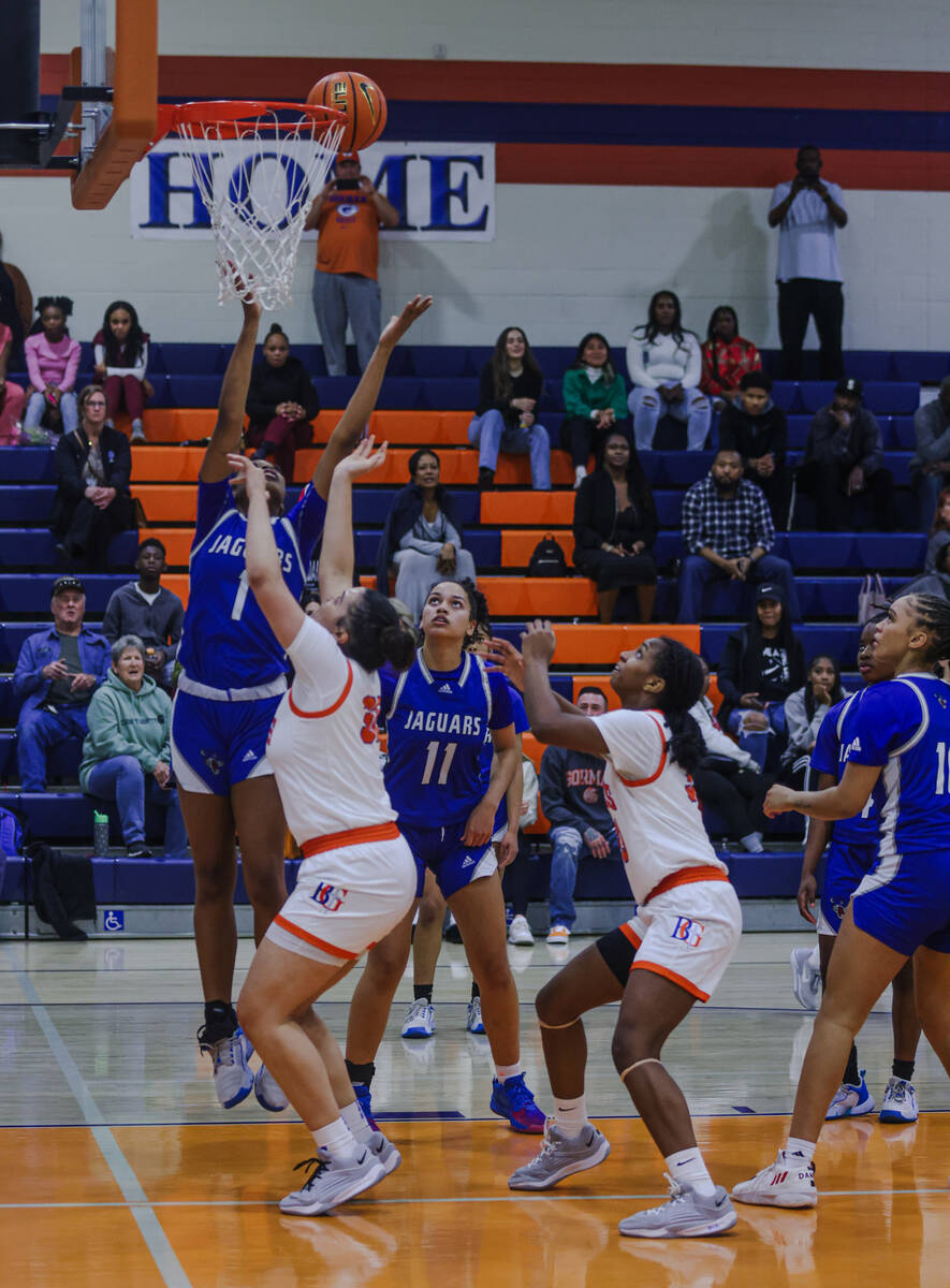 Bishop Gorman players try to secure a rebound shot against Desert Pines High School during a ga ...