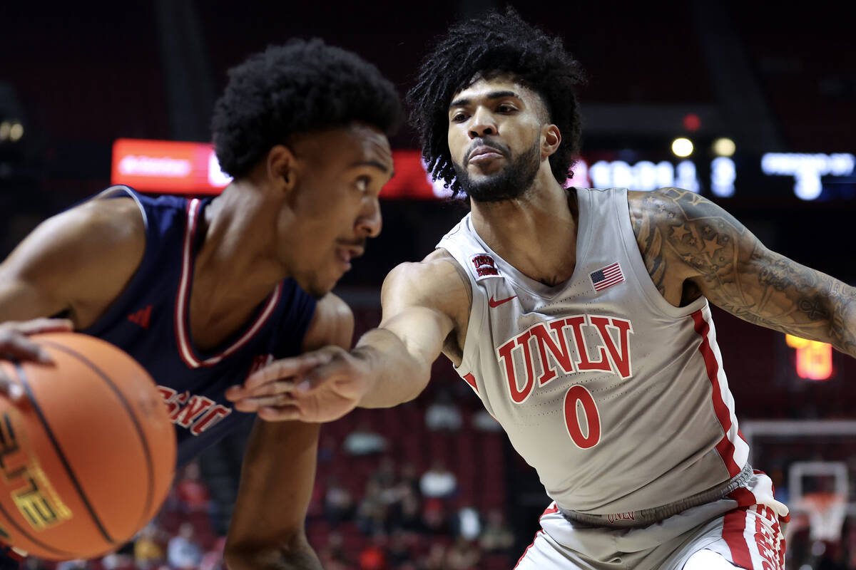 UNLV Rebels forward Isaiah Cottrell (0) defends against Fresno State Bulldogs guard Leo Colimer ...