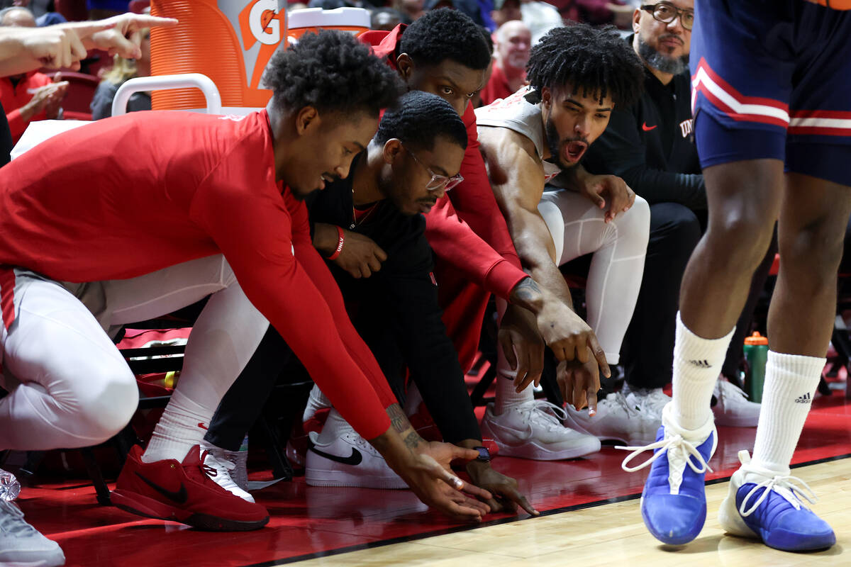 The UNLV Rebels bench point to where Fresno State stepped out-of-bounds during the second half ...