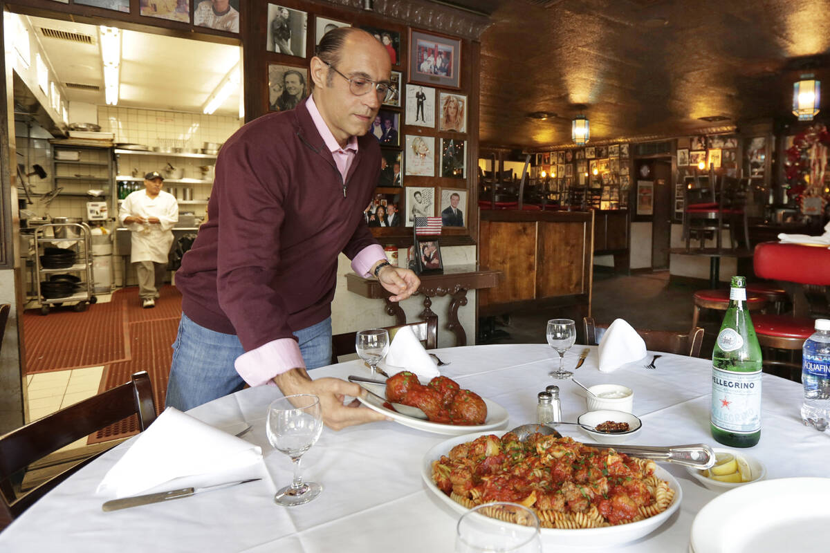 In this Oct. 24, 2016 photo, Frank Pellegrino Jr. co-owner of Rao's, serves meatballs to accomp ...