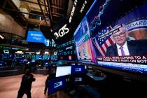 Federal Reserve Chairman Jerome Powell appears on a video monitor on the floor at the New York ...