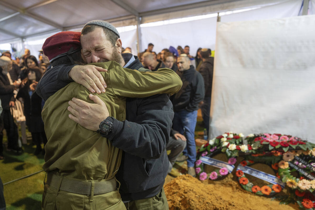 Mourners attend the funeral of reservist Gavriel Shani during his funeral at Mt. Herzl military ...