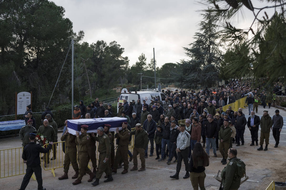 Israeli soldiers carry the flag-draped casket of reservist warrant officer Yuval Nir during his ...