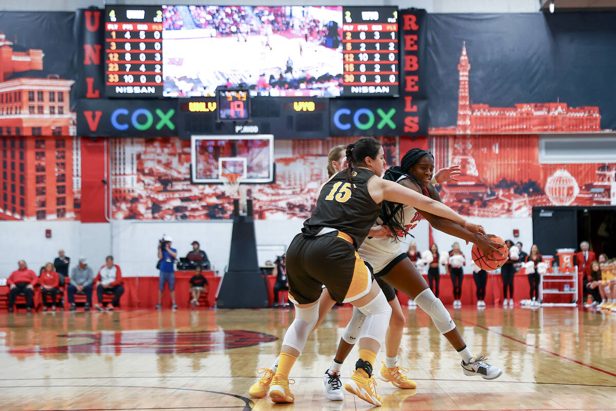 UNLV Lady Rebels center Desi-Rae Young (23) makes her way through Wyoming Cowgirls forward Mart ...
