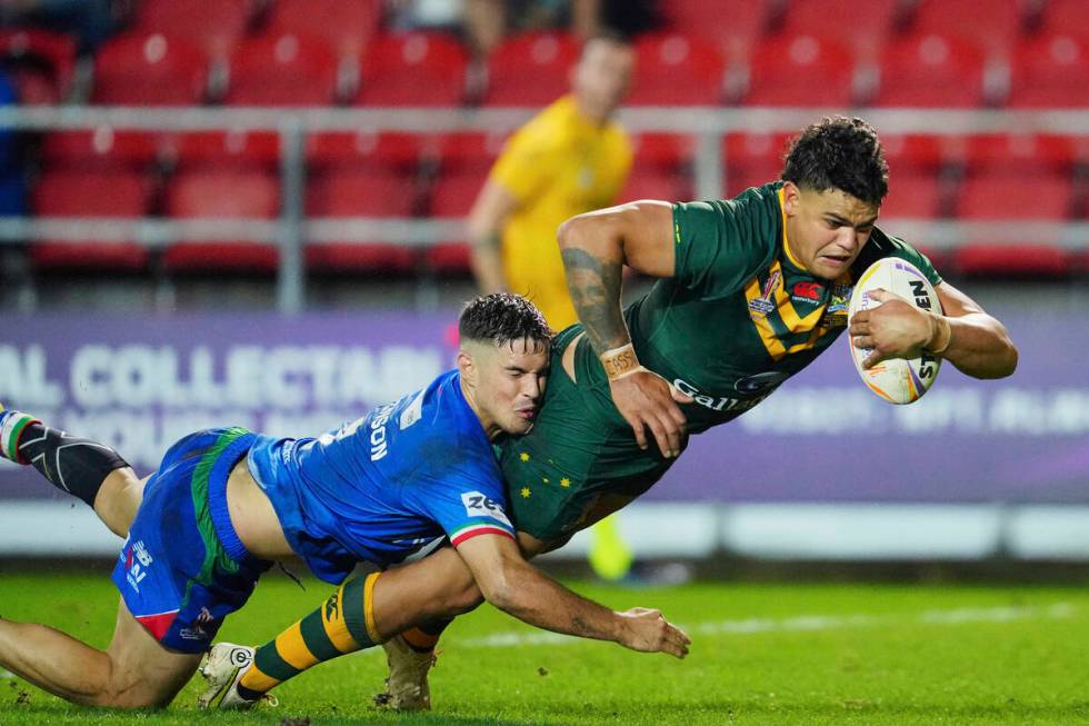FILE - Australia's Latrell Mitchell, right, scores a try as Italy's Radean Robinson tries to de ...