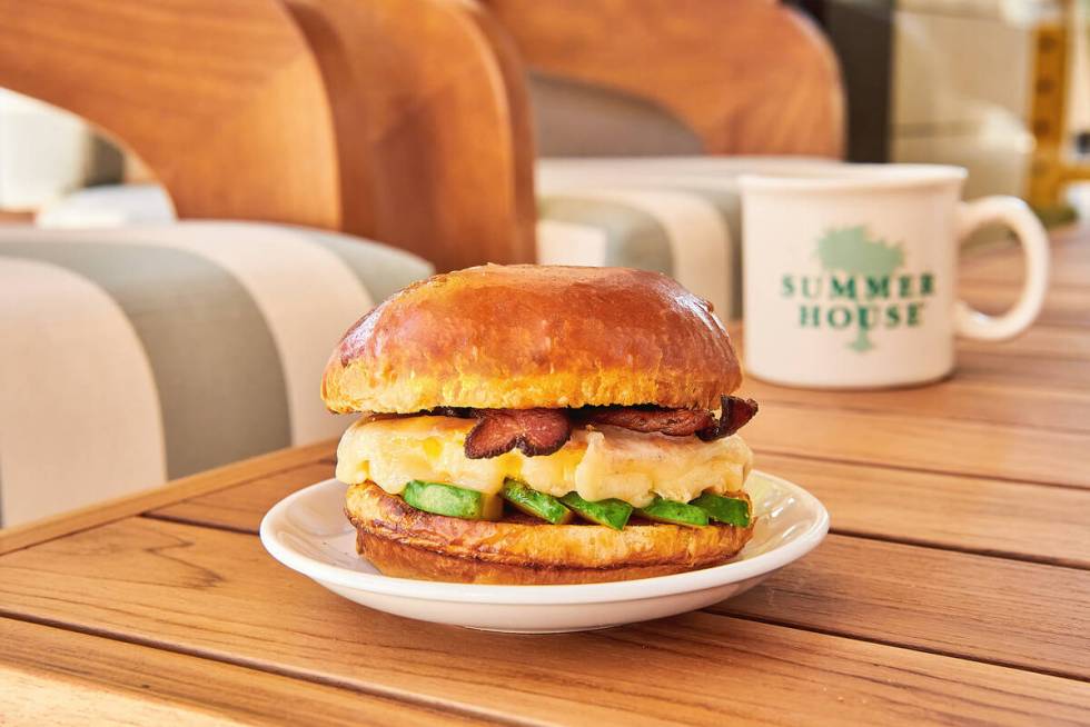 A weekend brunch sandwich of scrambled eggs, avocado and choice of meat on brioche from Summer ...