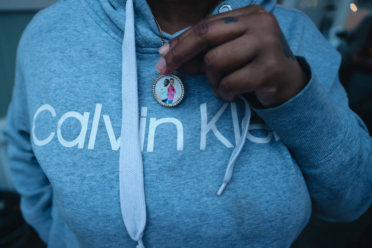 Katherine Patrick holds onto a necklace that she wears in memory of her two sons, Adrian and Ai ...