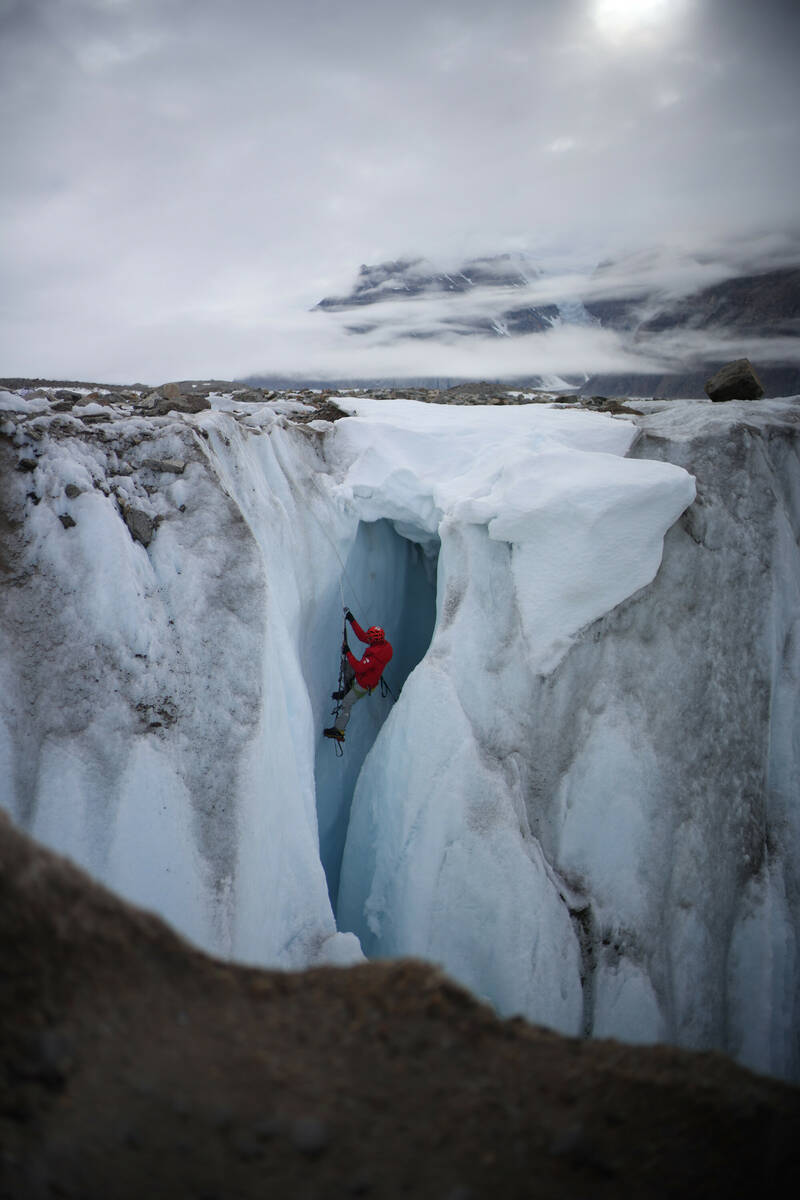 Alex Honnold climbs out of a moulin. (photo credit: National Geographic/JJ Kelley)