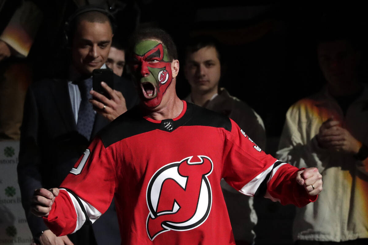 Actor Patrick Warburton, center, is dressed as Seinfeld cast member David Puddy, while walking ...