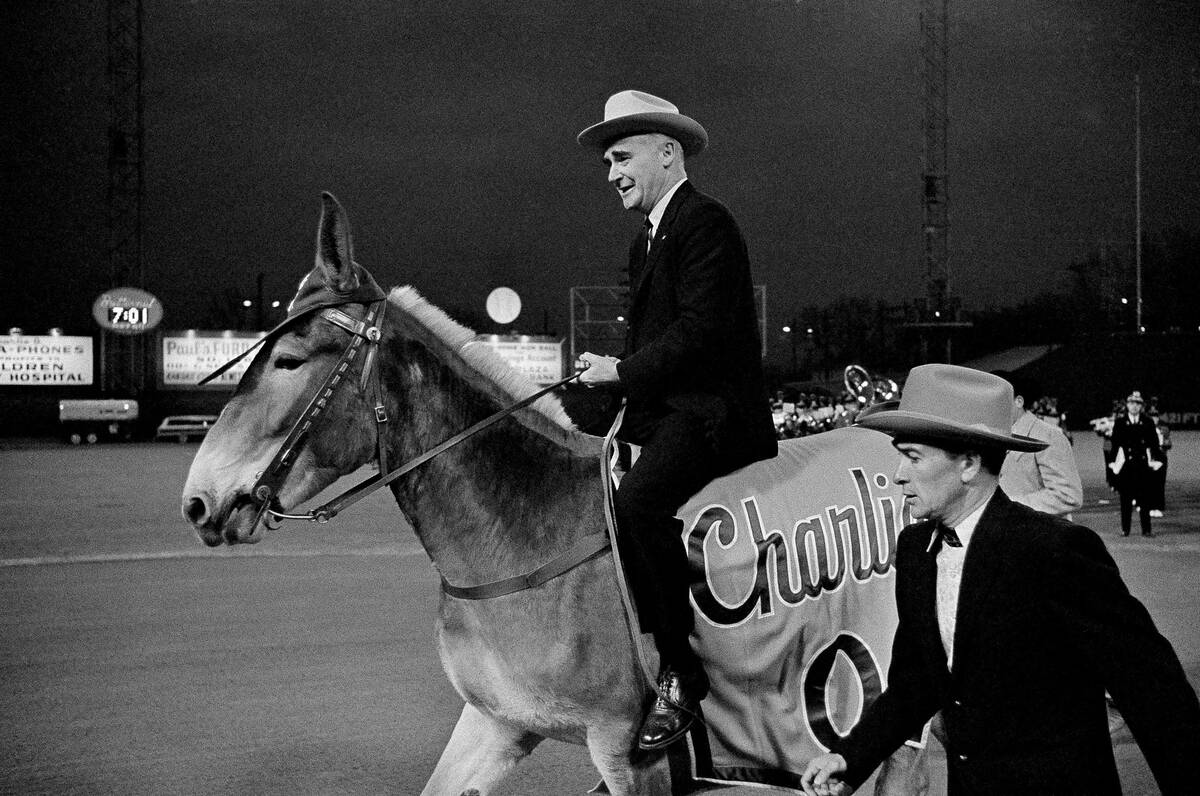 Kansas City Athletics owner Charlie Finley sits astride the team's mascot, "Charlie O,&quo ...