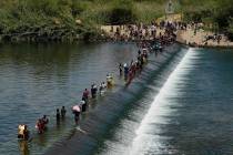 Haitian migrants use a dam to cross into the United States from Mexico in Del Rio, Texas. (AP P ...