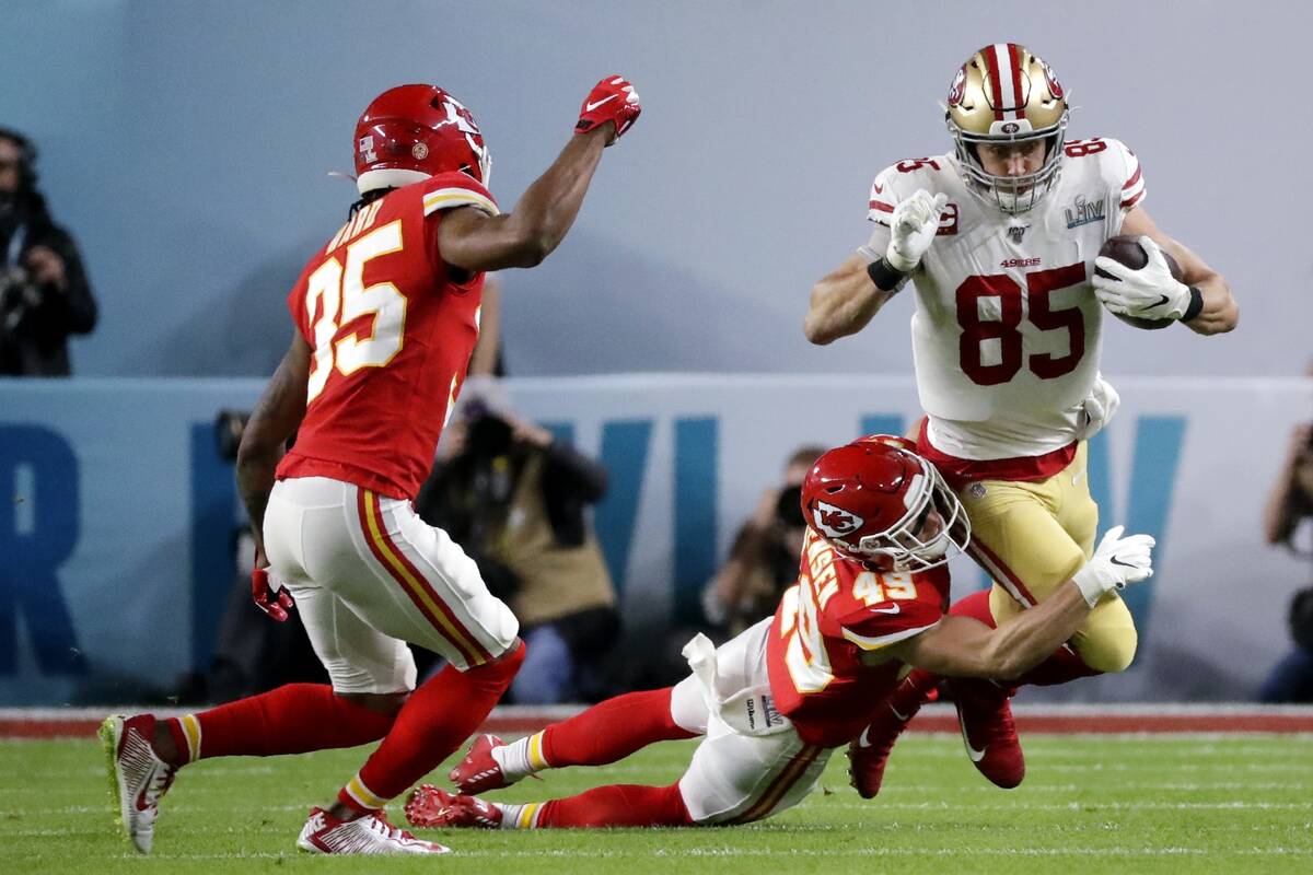 San Francisco 49ers' George Kittle (85) runs against Kansas City Chiefs' Daniel Sorensen (49) a ...