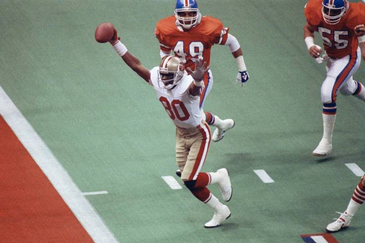 In this Jan. 28, 1990, file photo, San Francisco 49ers wide receiver Jerry Rice celebrates his ...