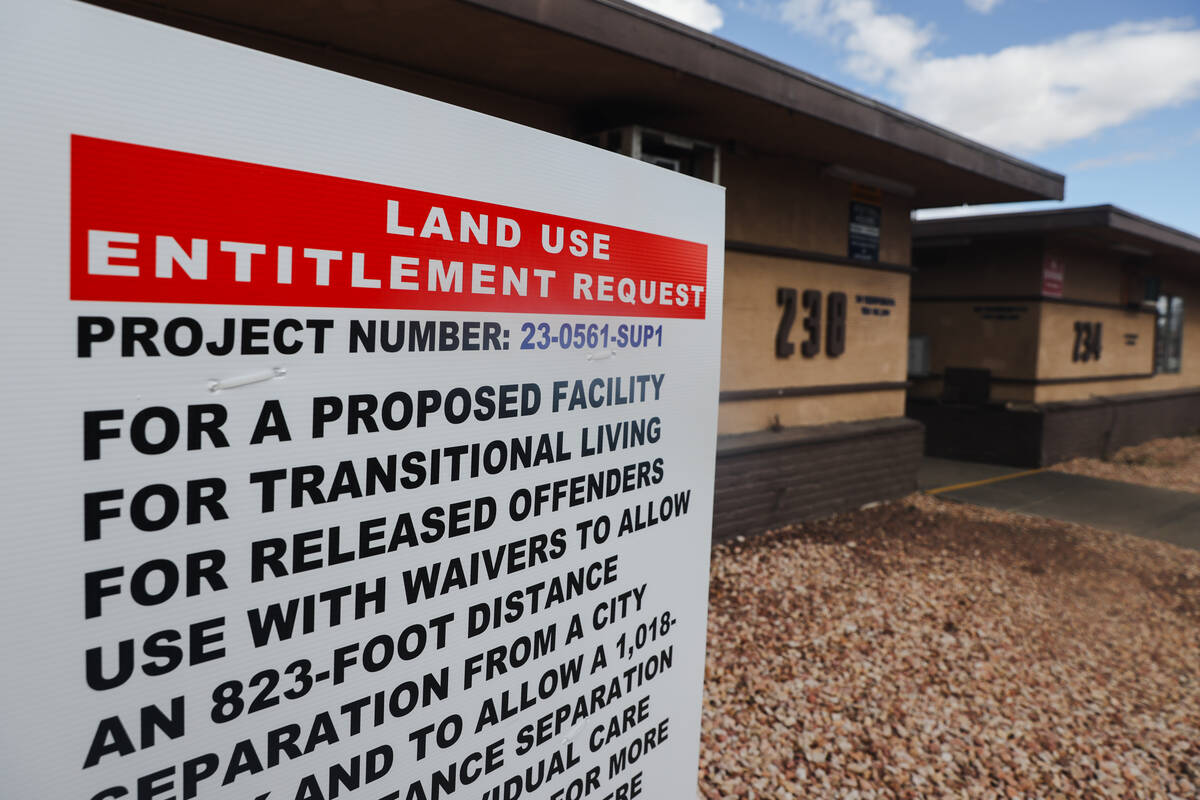 A sign for the proposed development of a transitional living facility for newly released offend ...