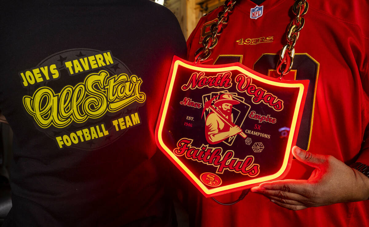 Owner Joey Johnson, left, with his custom t-shirt and Gaston Larsen with his custom sign as mem ...