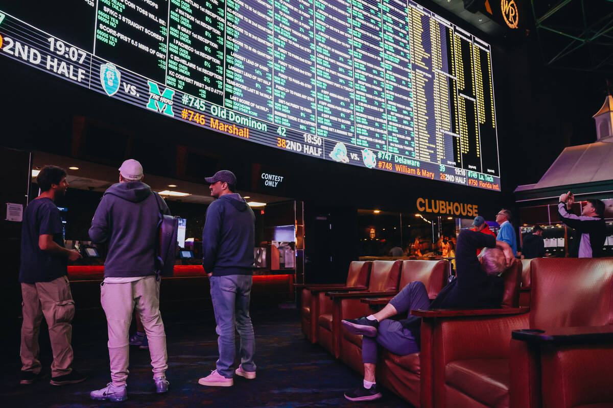 Bettors wait to cast bets from a menu of Super Bowl props at the Westgate SuperBook on Thursday ...