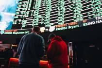 Bettors take notes on a menu of Super Bowl props at the Westgate SuperBook on Thursday, Feb. 1, ...