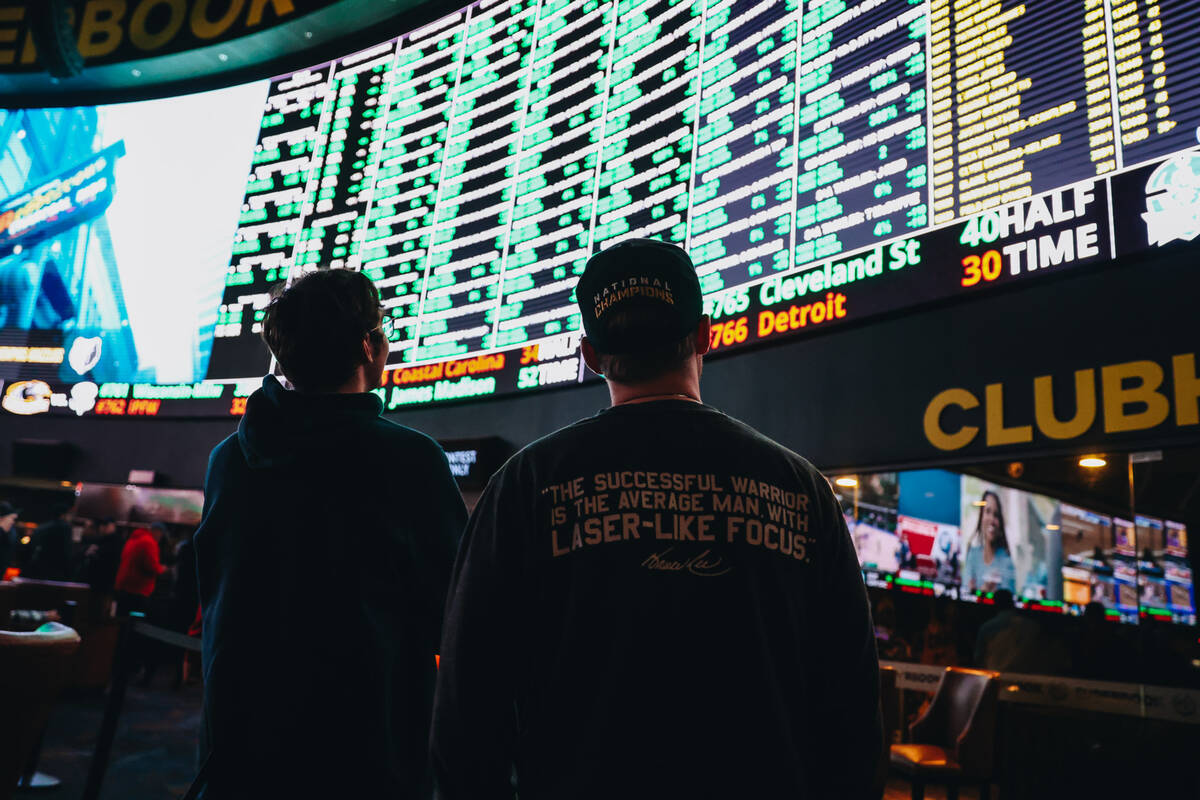 Spectators take in a large menu of Super Bowl props at the Westgate SuperBook on Thursday, Feb. ...