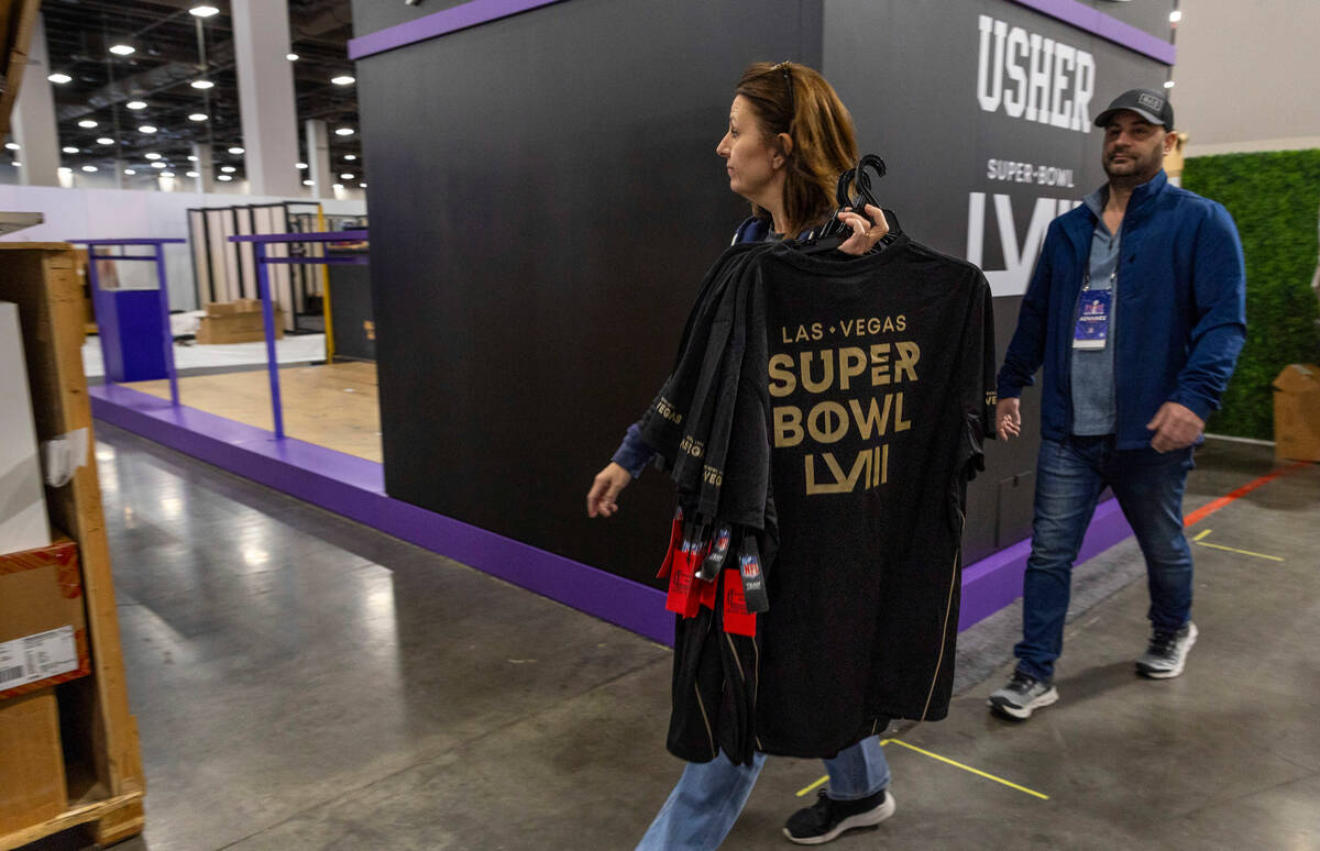 T-shirts for sale are brought into the NFL store being set up for the Super Bowl experience...
