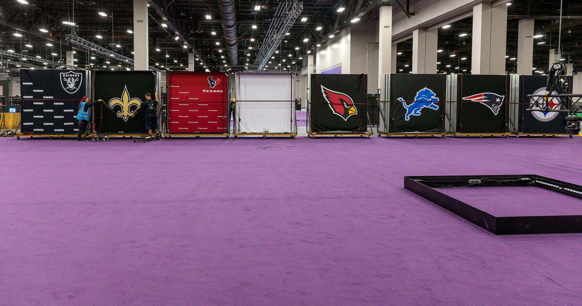 Team logo panels are installed as set up continues for the Super Bowl Experience at the Mandala ...
