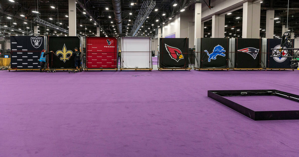 Team logo signs are installed as set-up continues for the Super Bowl experience at Mandala...