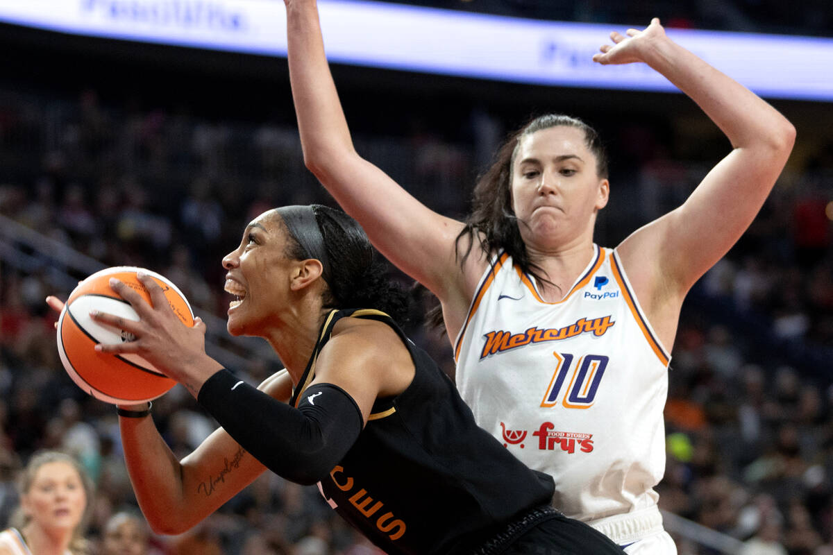 Las Vegas Aces forward A'ja Wilson (22) fights toward the hoop against Phoenix Mercury center M ...