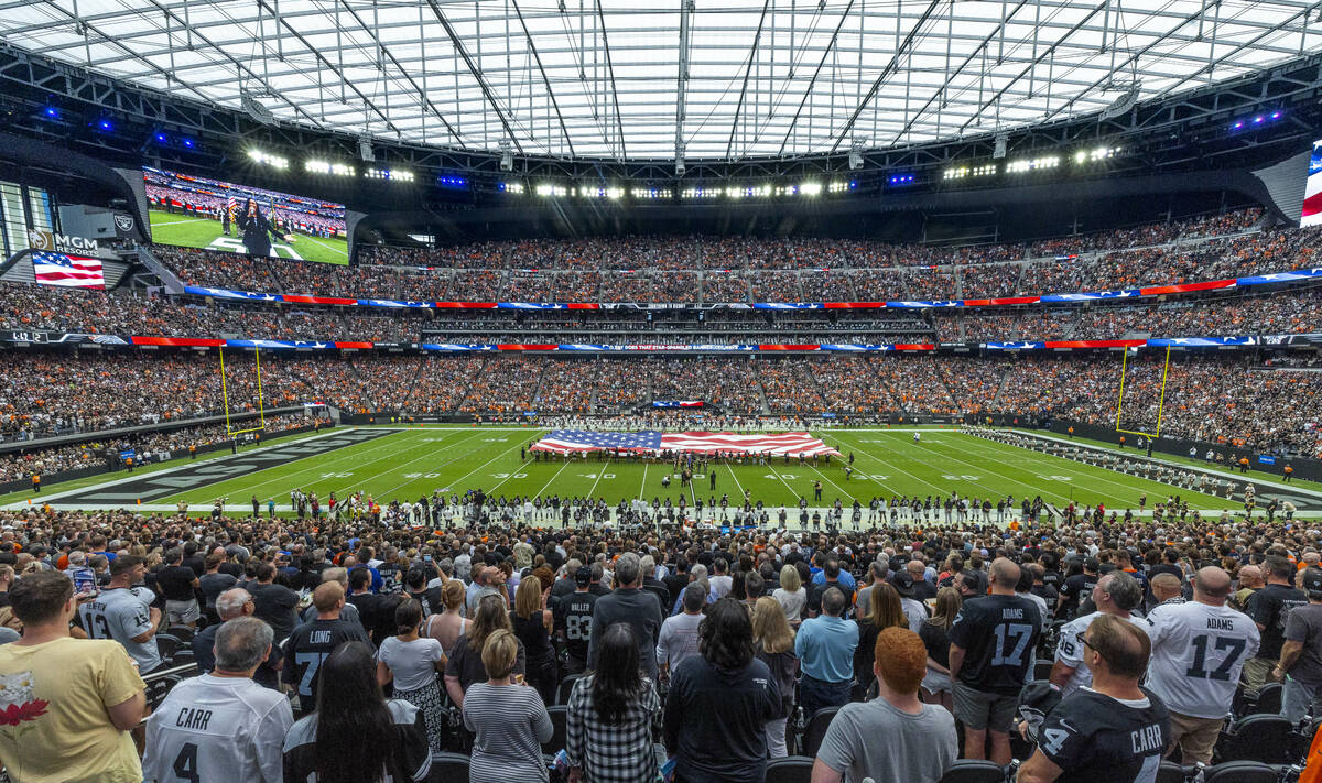 The American flag is unfurled for the National Anthem before the Raiders face the Denver Bronco ...