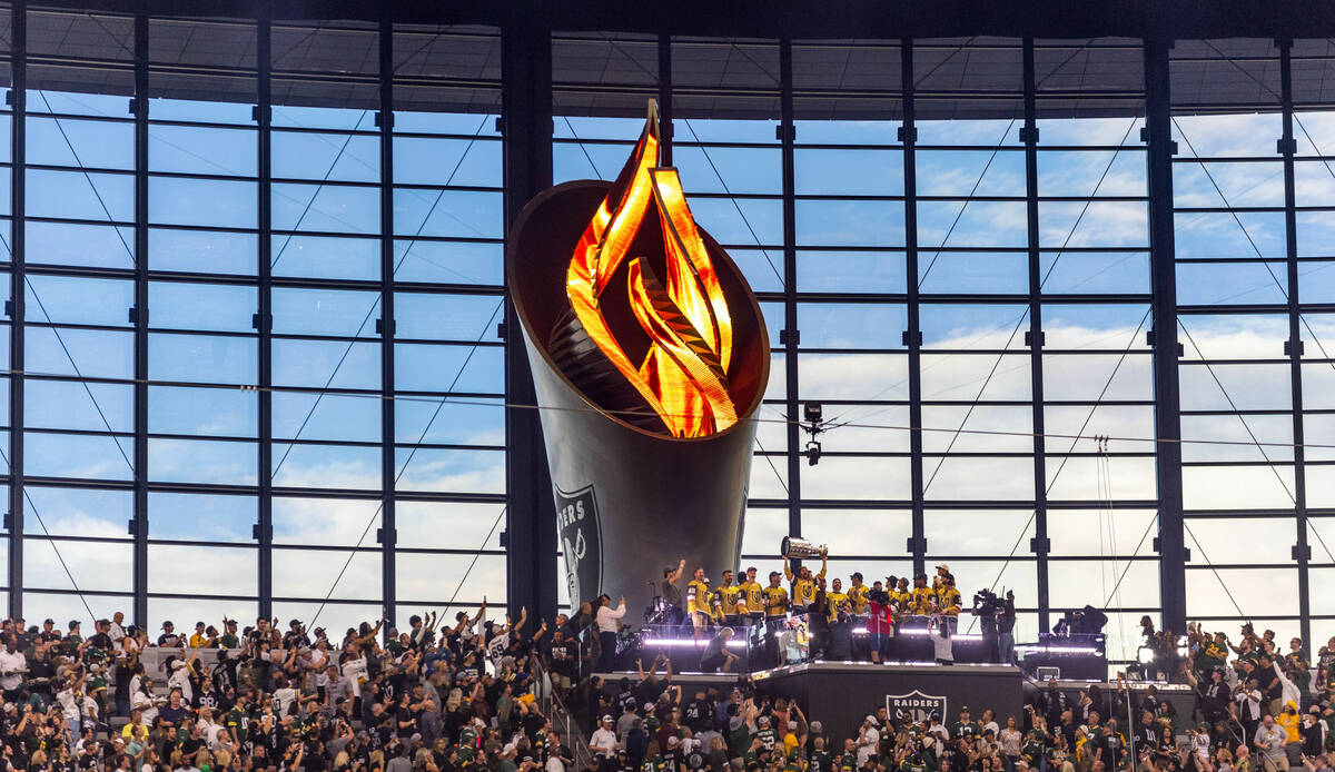 The Golden Knights with the Stanley Cup in the air for the torch lighting as the Raiders face t ...