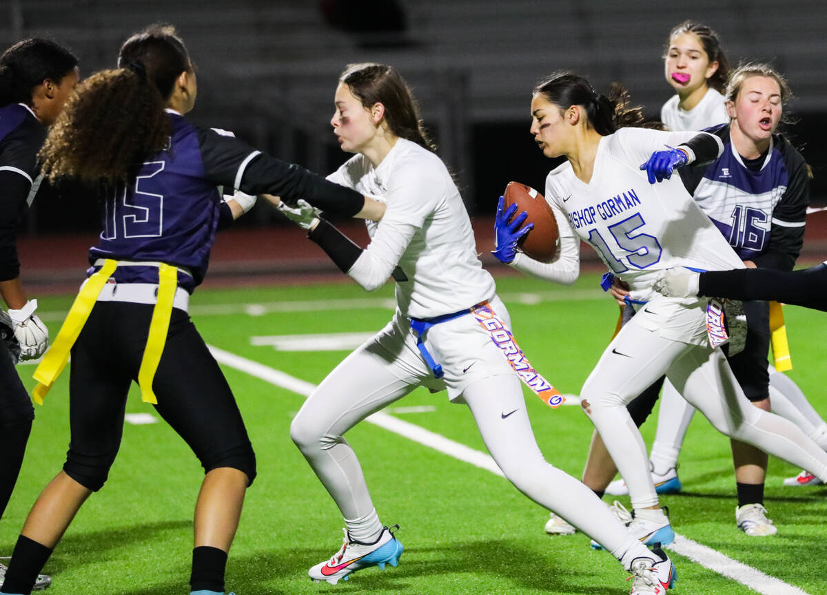 Bishop Gorman’s Alana Moore (15) charges through others during a flag football game betw ...
