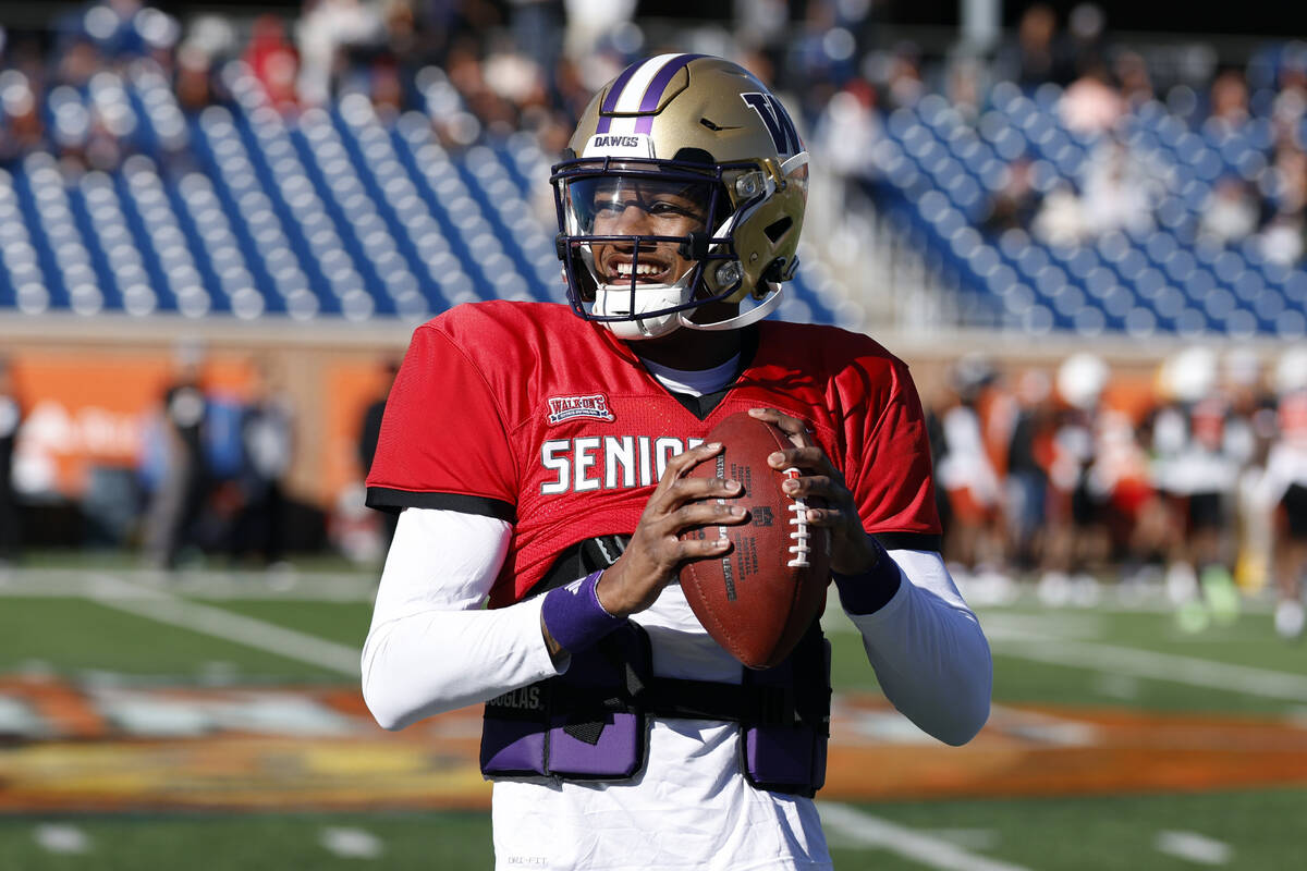 National quarterback Michael Penix Jr. of Washington runs through drills during practice for th ...