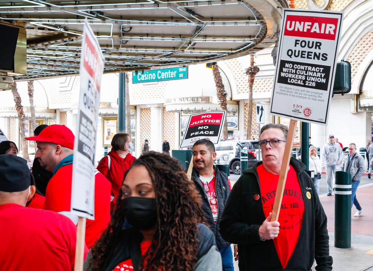 Members of the Culinary Union picket outside of Four Queens Hotel & Casino on Friday, Feb. ...