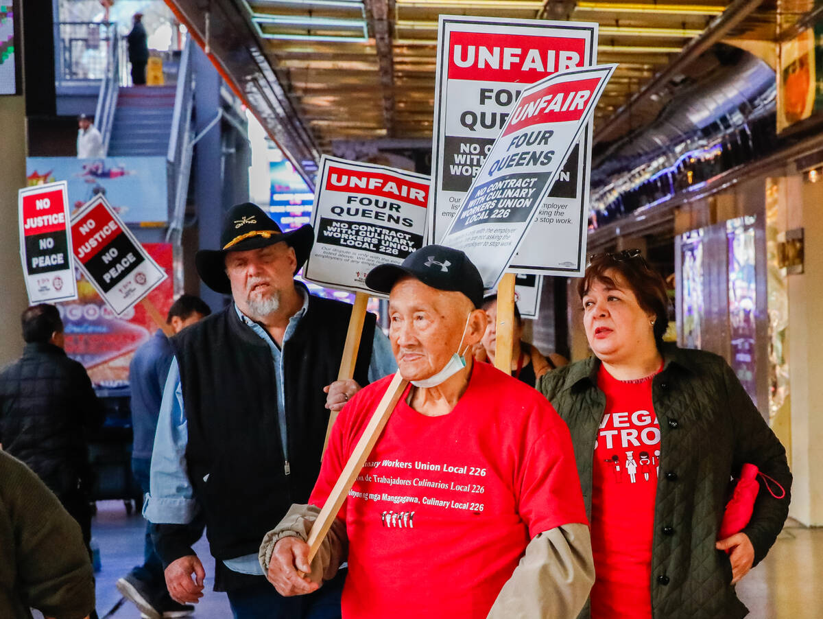 Members of the Culinary Union picket outside of Four Queens Hotel & Casino on Friday, Feb. 2, 2 ...