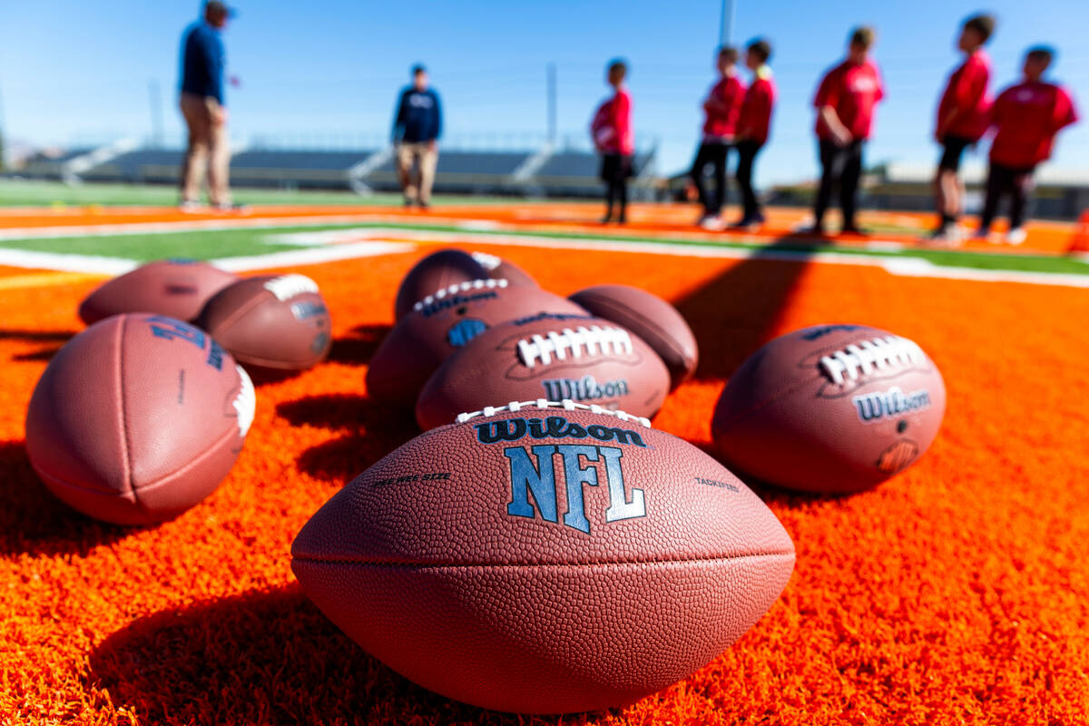 Footballs are ready for usage during the Punt, Pass and Kick National Finals at Mojave High Sch ...