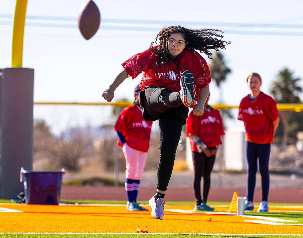 Aaliyah Medrano of McAllen, Texas, a 10/11-year-old girl's contestant, punts the ball during th ...