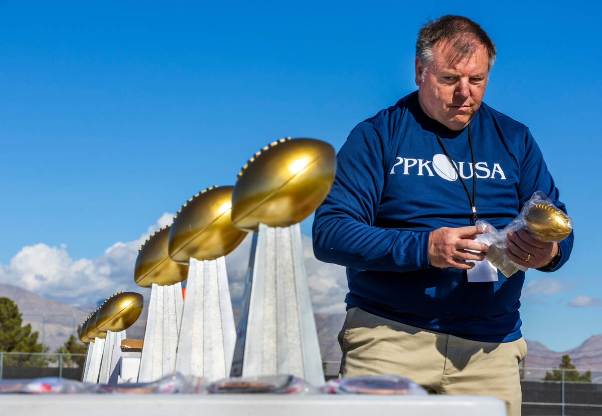 Executive Director Frank Wittenberg from Lafayette, LA., arranges trophies and medals for conte ...