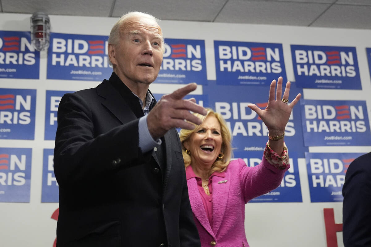 President Joe Biden, left, and first lady Jill Biden visit the Biden campaign headquarters in W ...