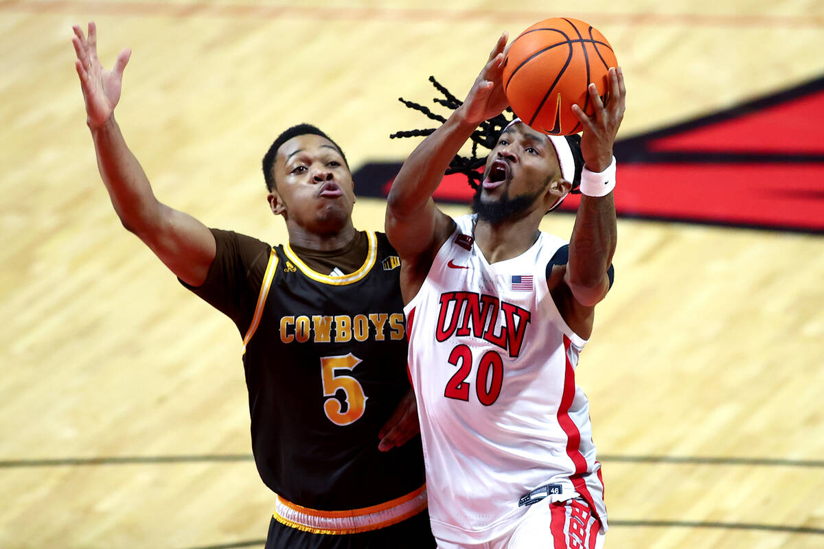 UNLV Rebels forward Keylan Boone (20) shoots against Wyoming Cowboys forward Cam Manyawu (5) du ...