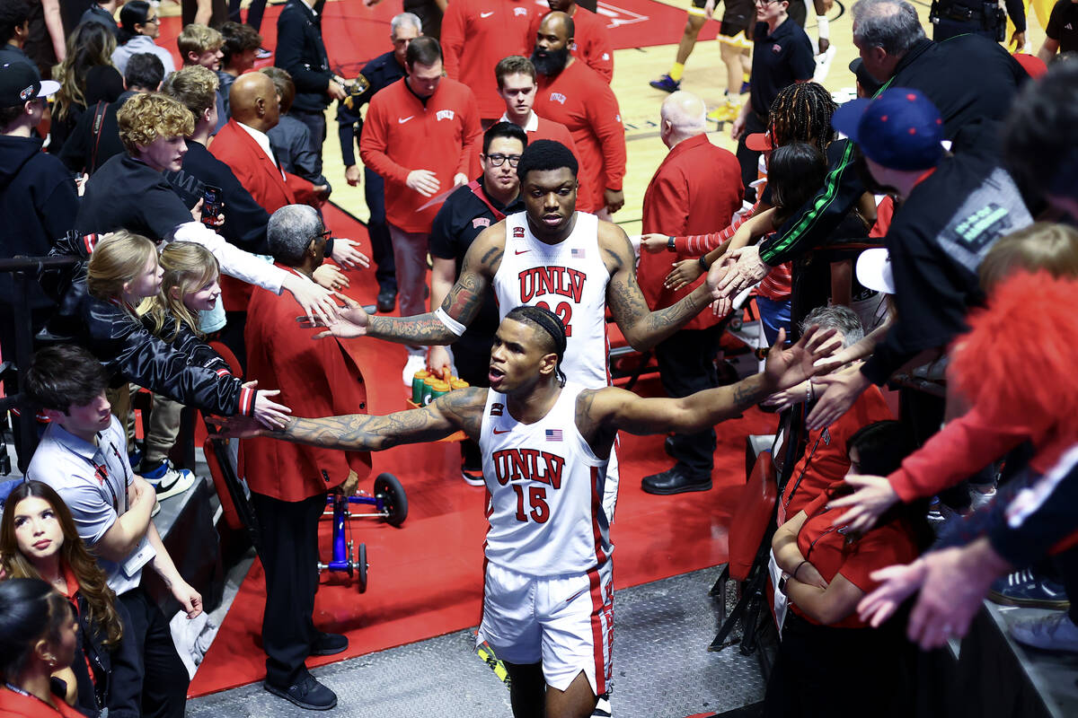 UNLV Rebels guard Luis Rodriguez (15) slaps hands with fans after winning an NCAA college baske ...