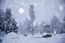 In this photo provided by the Mammoth Mountain Ski Area, cars and buildings are covered in snow ...