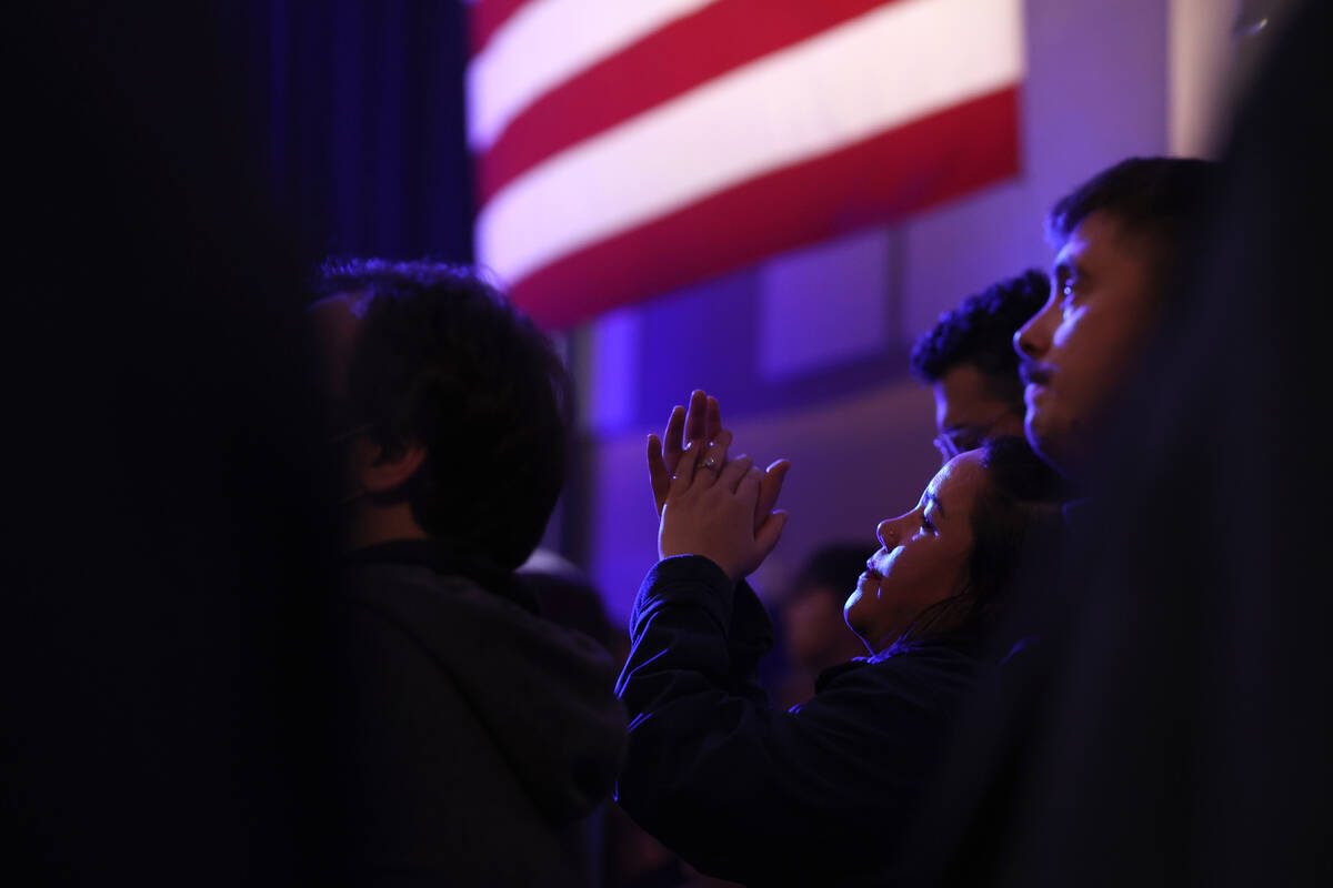 A Democratic supporter applauds President Joe Biden as he speaks during a campaign event ahead ...