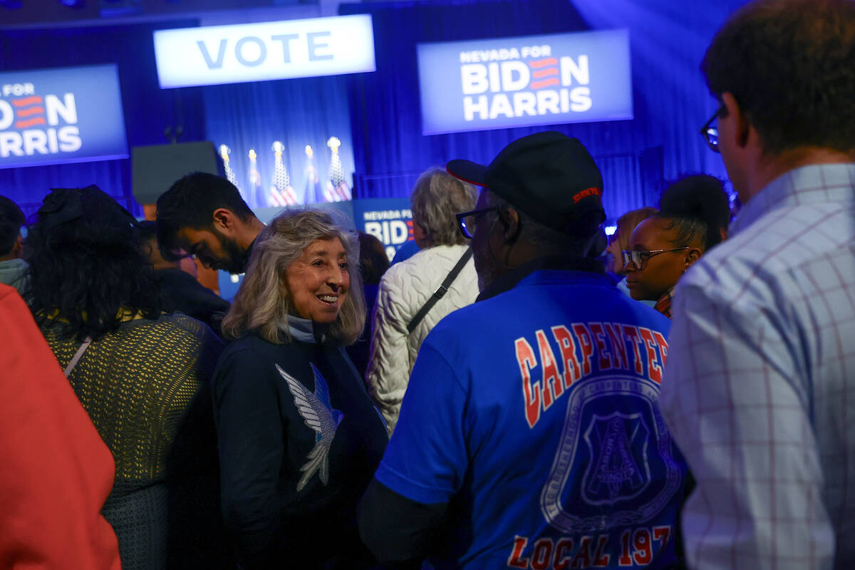 Rep. Dina Titus, D-Nev., mingles with voters while waiting for President Joe Biden to speak dur ...