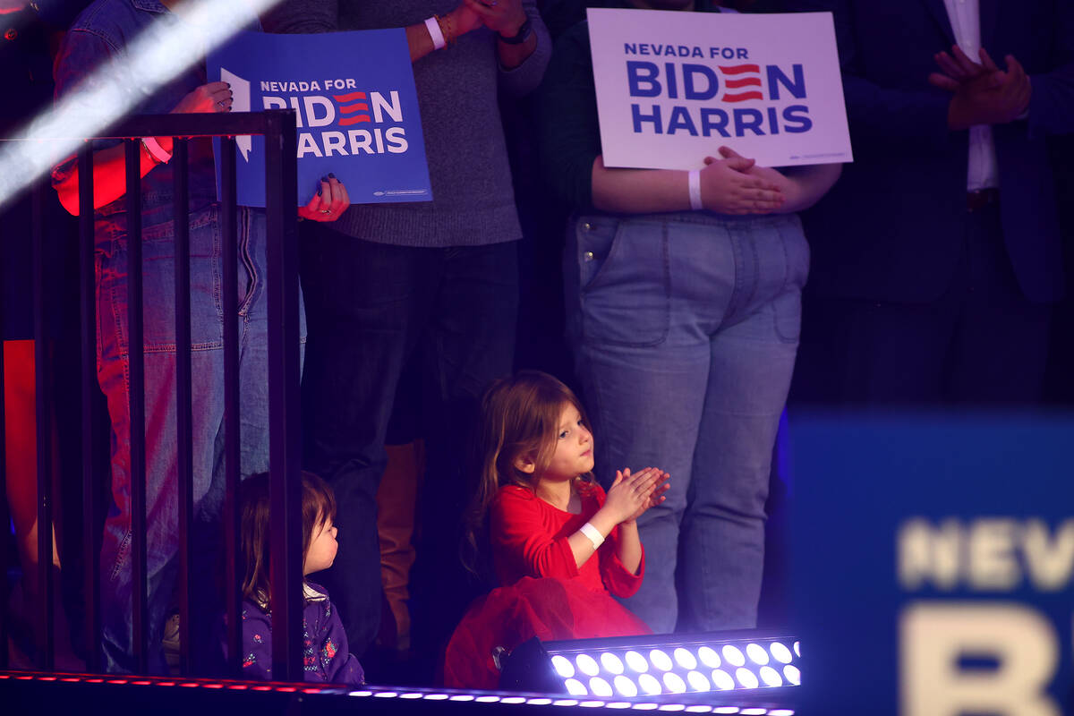 Nevadans clap on stage while President Joe Biden speaks during a campaign event ahead of the Ne ...
