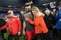 Kansas City Chiefs tight end Travis Kelce and Taylor Swift walk together after an AFC Champions ...